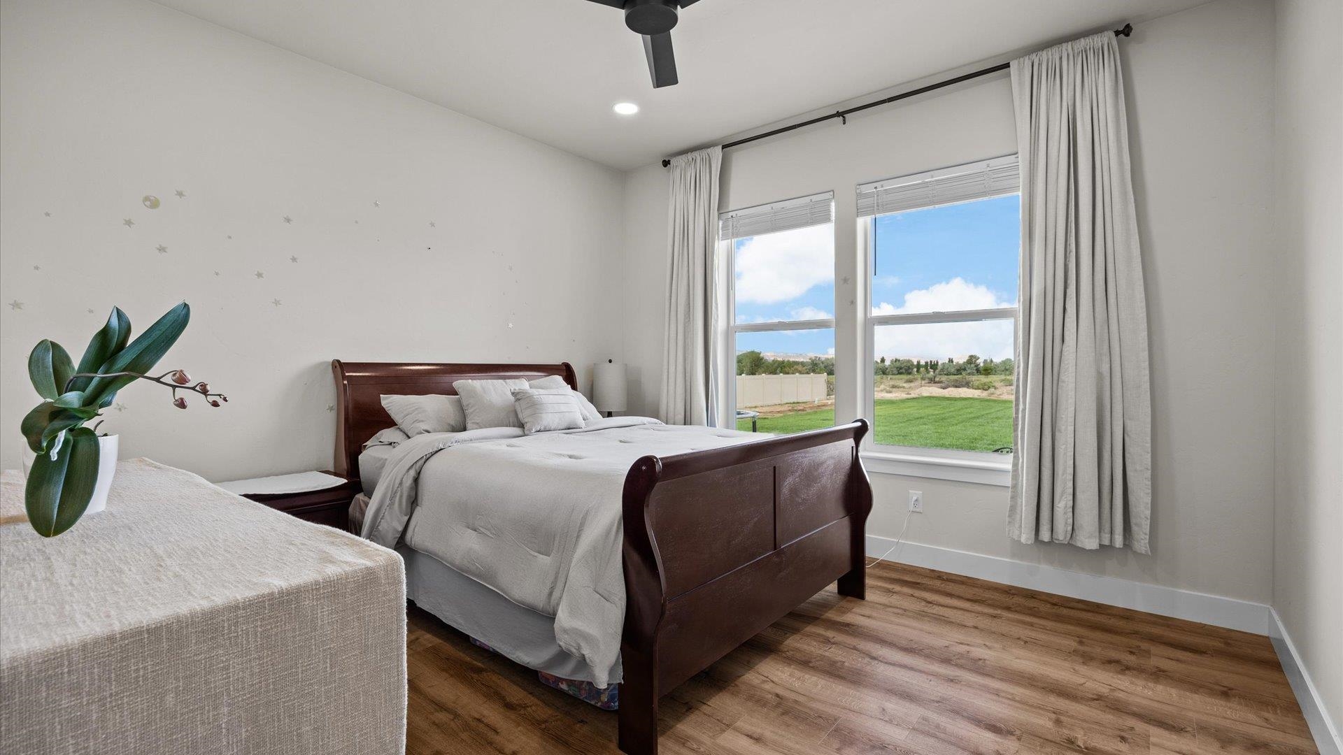 1730 Stremel Creek Fruita, CO 81521 - Photo 23 of 42 a bed sitting in a bedroom next to a window