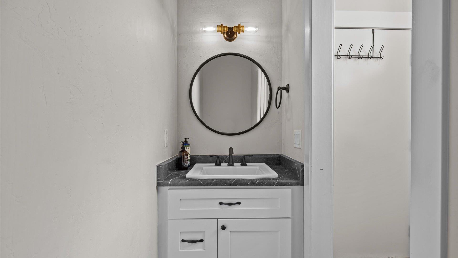 1730 Stremel Creek Fruita, CO 81521 - Photo 26 of 42 a bathroom with a granite countertop sink and a mirror