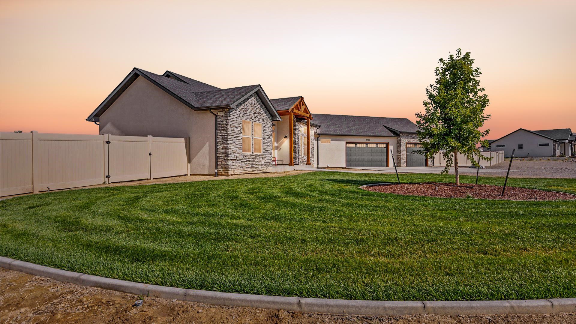 1730 Stremel Creek Fruita, CO 81521 - Photo 4 of 42 a front view of a house with a yard