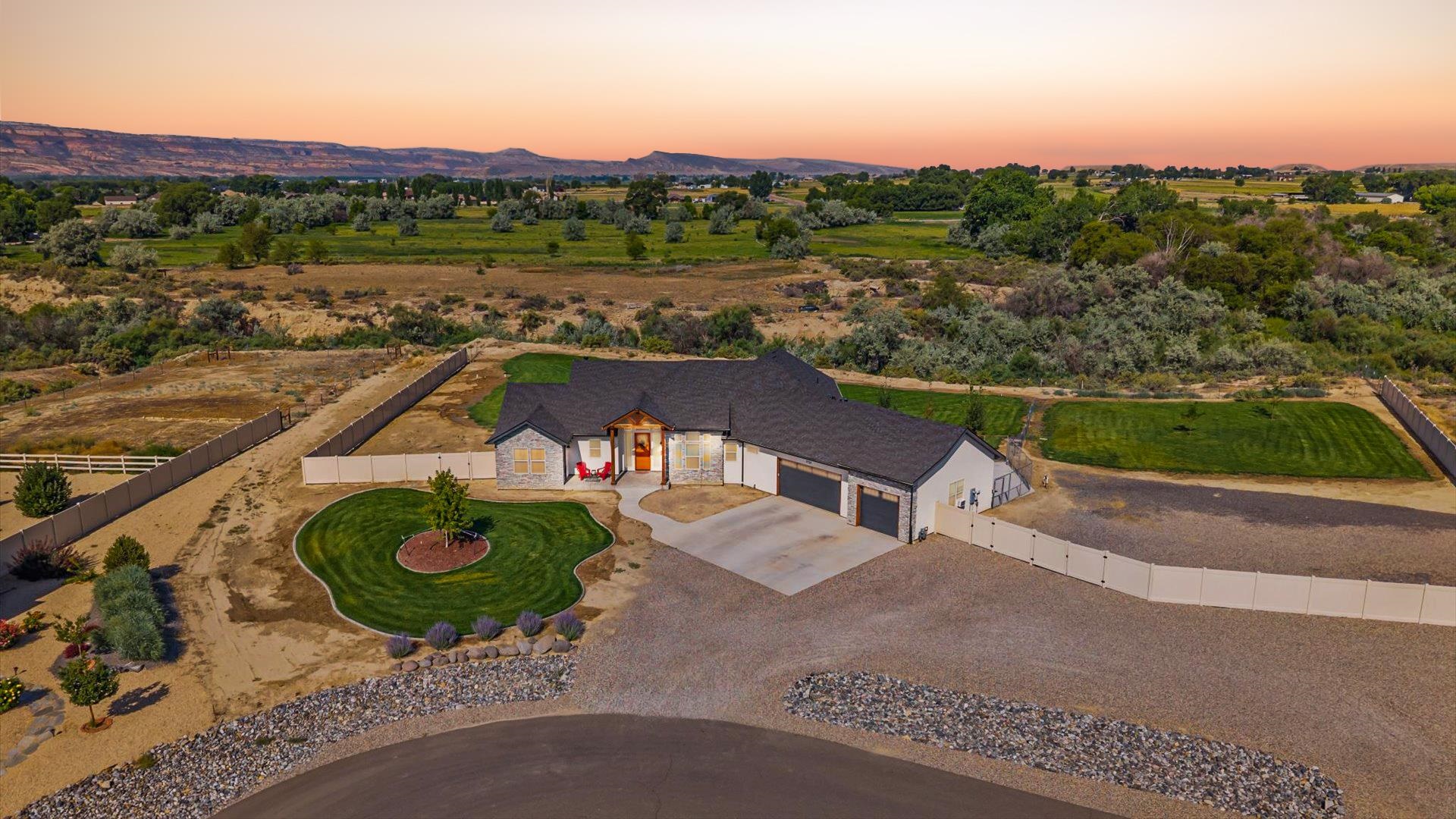 1730 Stremel Creek Fruita, CO 81521 - Photo 6 of 42 an aerial view of a house with a garden and lake view