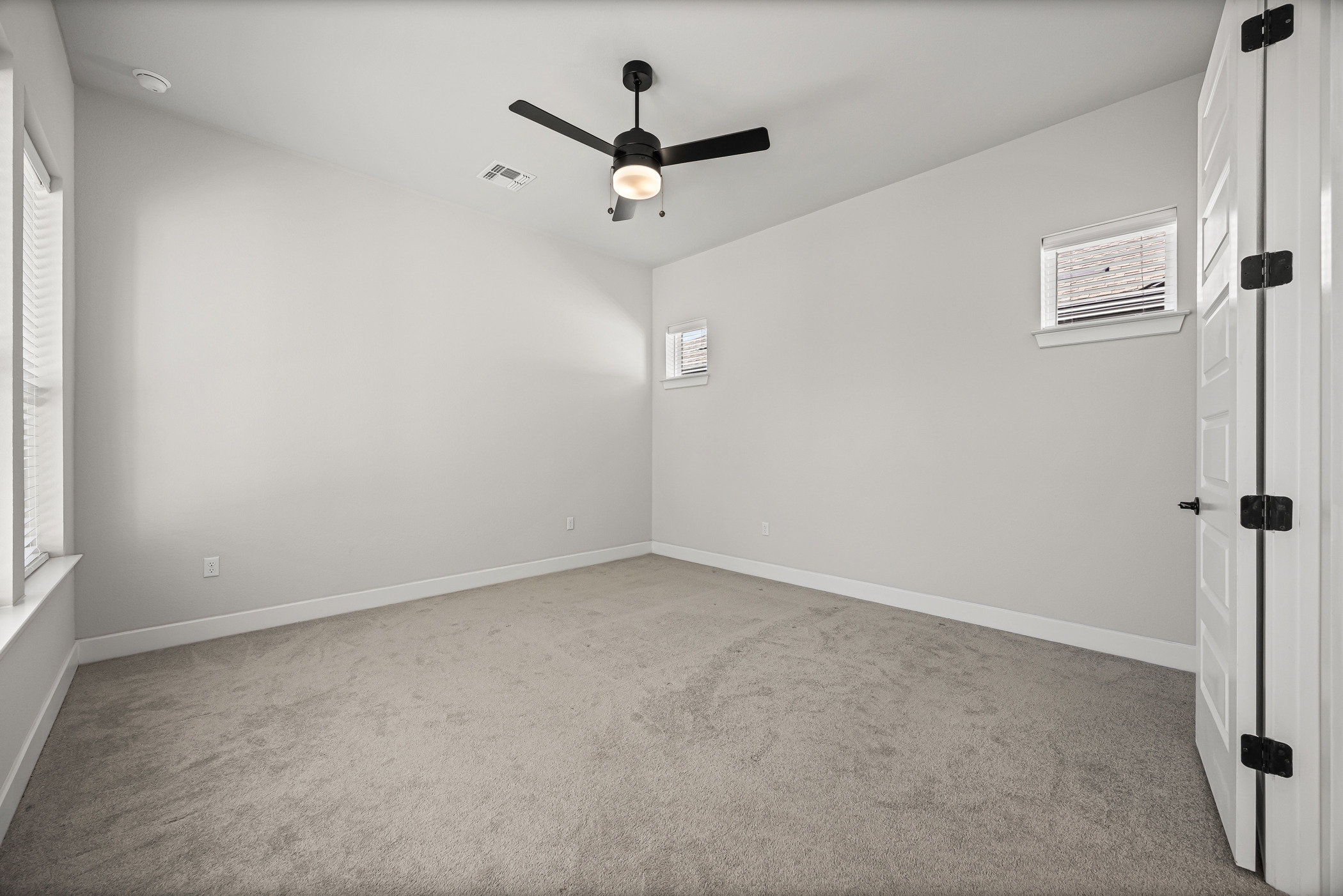 5806 Rangeland Road Austin, TX 78747 - Photo 19 of 34 A spacious bedroom awaits personalization, featuring a modern ceiling fan and natural light.