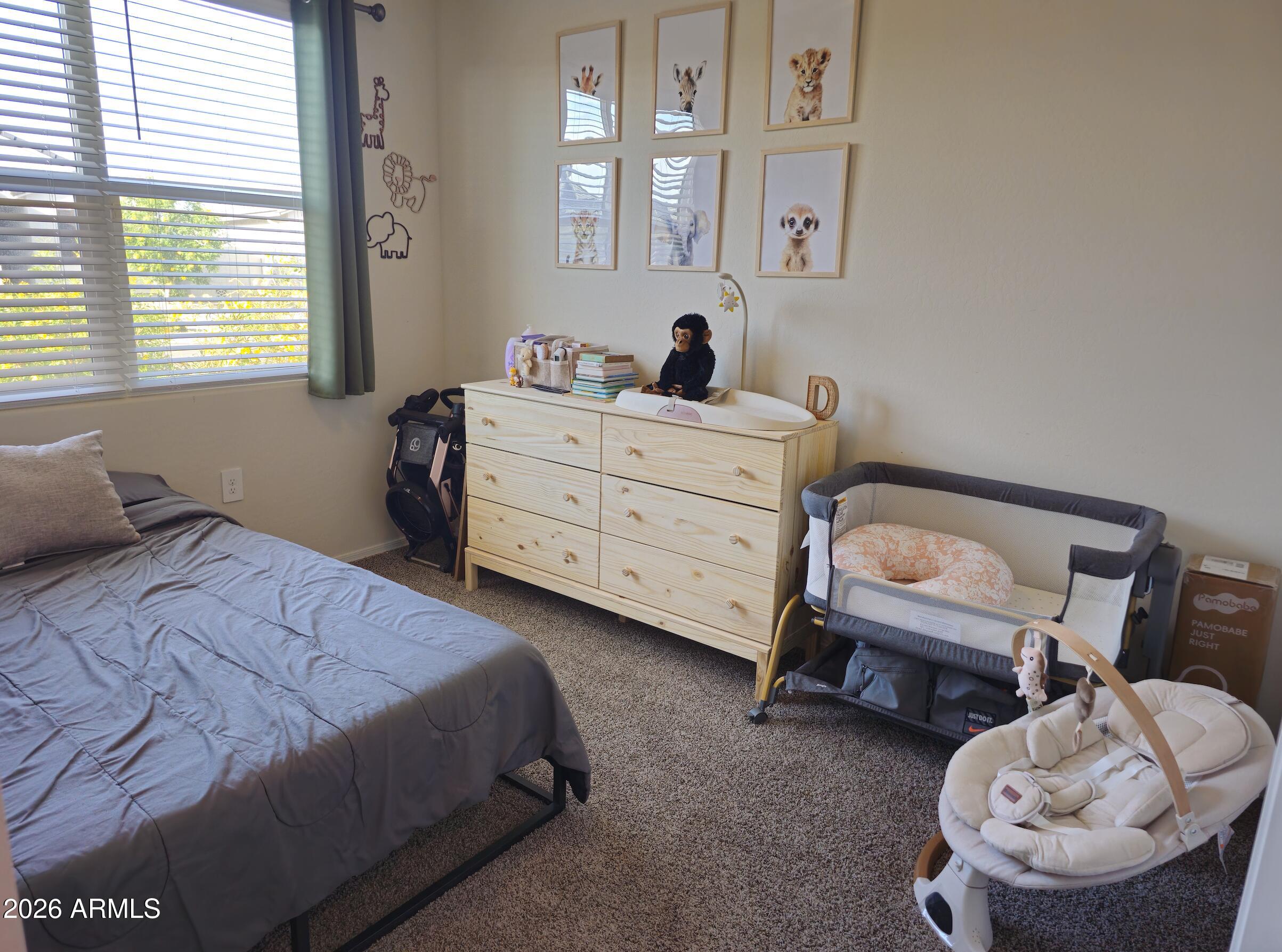 9434 Cotton Road Florence, AZ 85132 - Photo 21 of 25 a bedroom with a bed and a chair