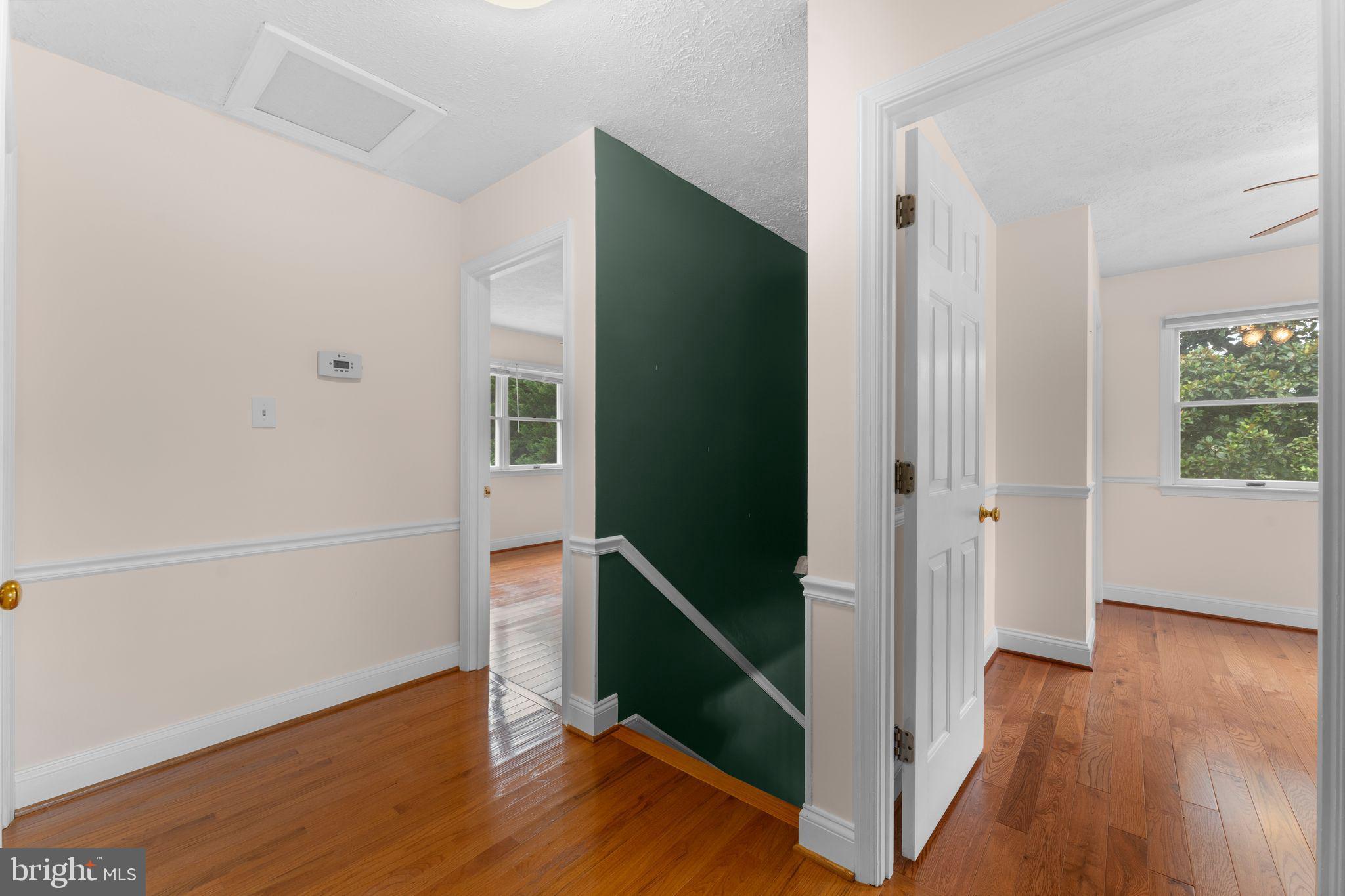 13360 Cameron Court Boston, VA 22713 - Photo 59 of 76 a view of a hallway with wooden floor and stairs