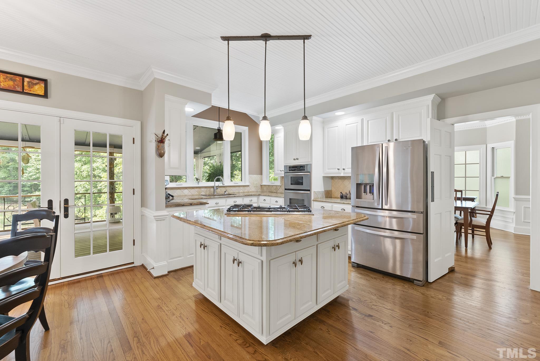 1113 Bentham Drive Raleigh, NC 27614 - Photo 11 of 78 a kitchen with stainless steel appliances granite countertop a refrigerator a stove a sink and a dining table with wooden floor