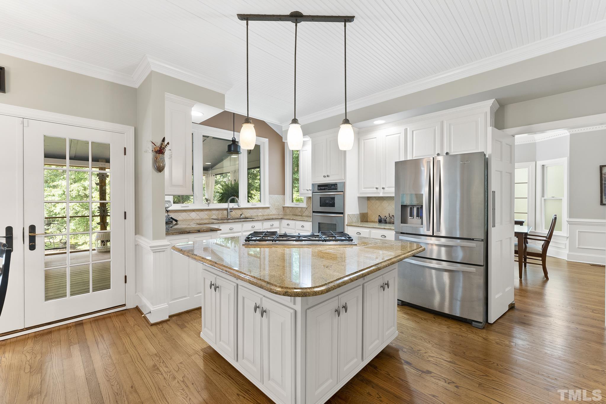1113 Bentham Drive Raleigh, NC 27614 - Photo 12 of 78 a kitchen with stainless steel appliances granite countertop a refrigerator a sink a stove and a wooden floors