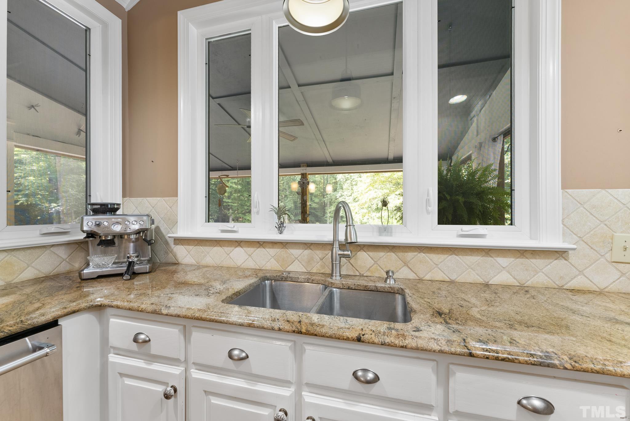 1113 Bentham Drive Raleigh, NC 27614 - Photo 15 of 78 a kitchen with granite countertop a sink and a window