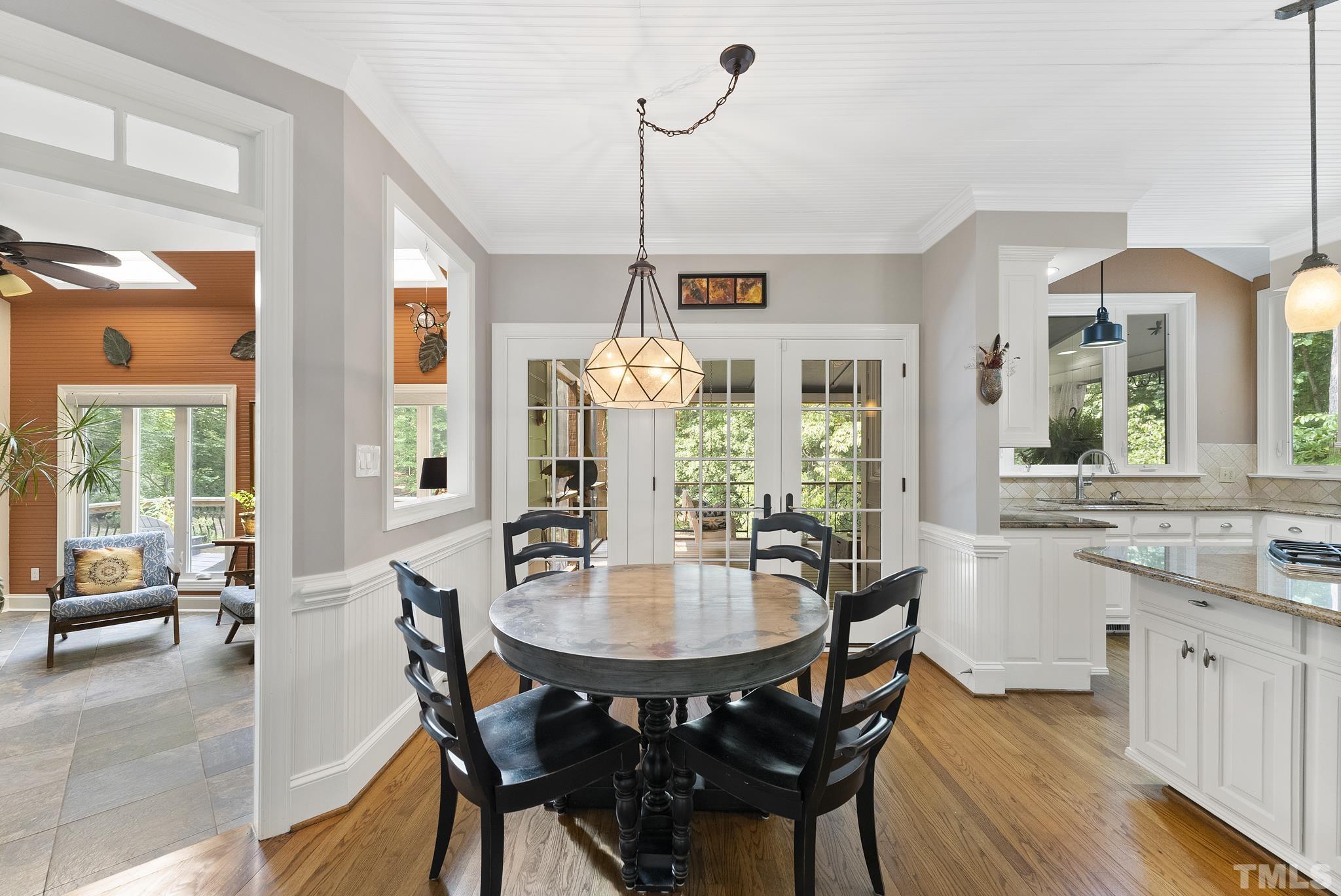 1113 Bentham Drive Raleigh, NC 27614 - Photo 18 of 78 a dining room with furniture a chandelier and wooden floor