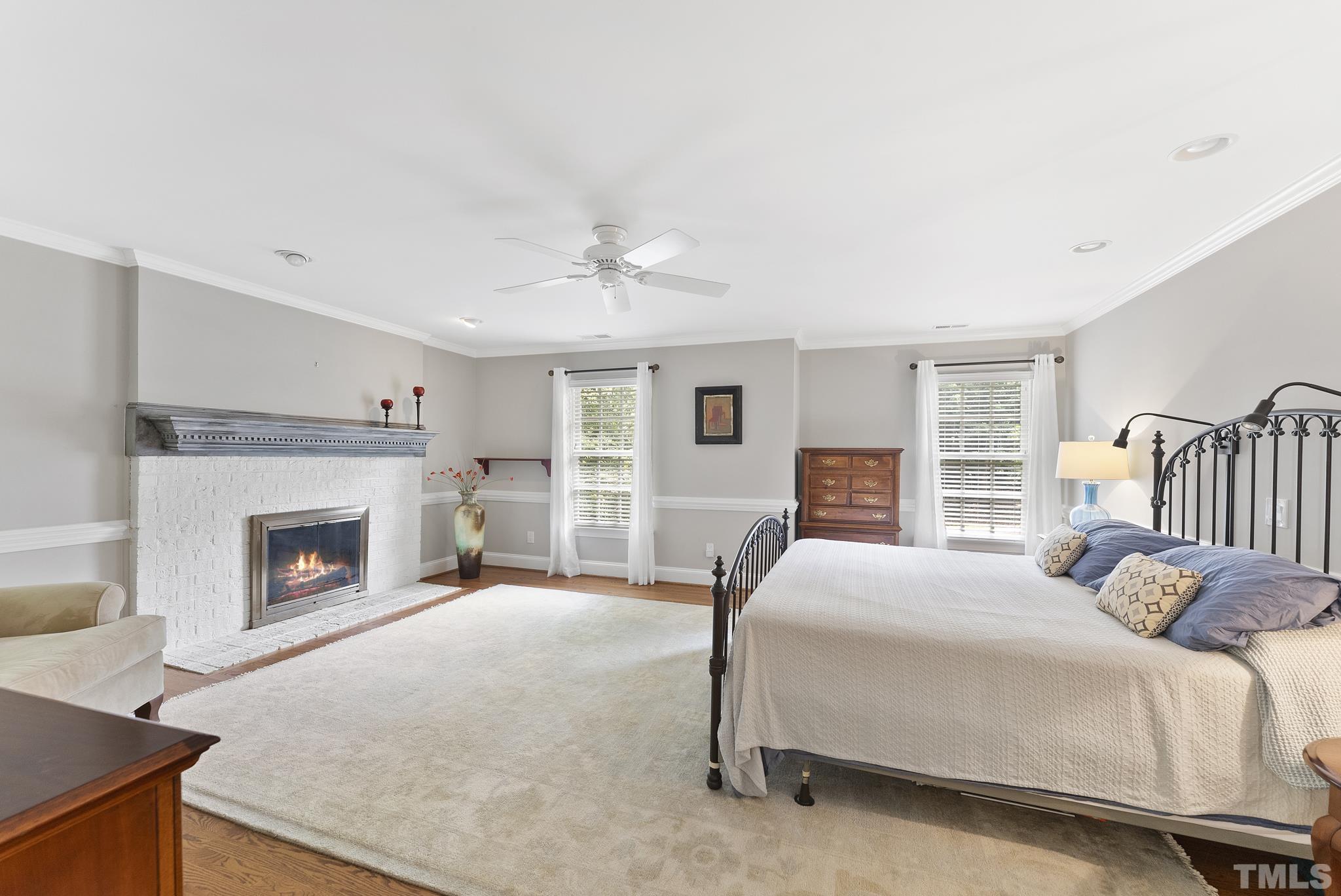 1113 Bentham Drive Raleigh, NC 27614 - Photo 27 of 78 a spacious bedroom with a bed and a fireplace