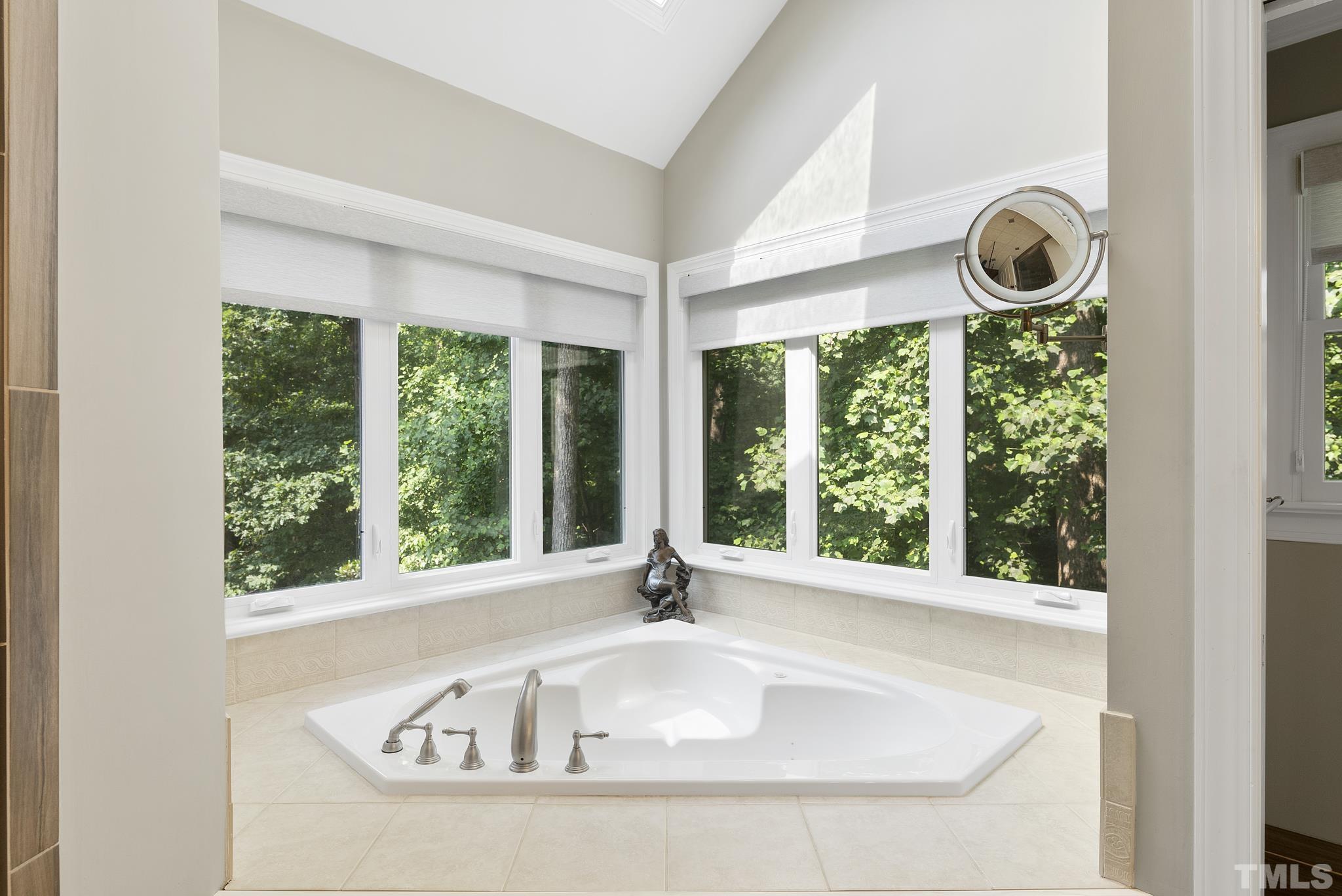 1113 Bentham Drive Raleigh, NC 27614 - Photo 30 of 78 a white bath tub sitting in a bathroom next to a window