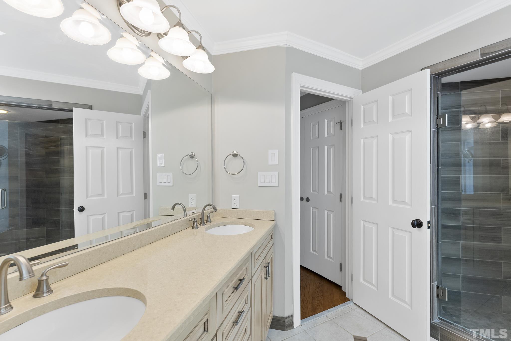 1113 Bentham Drive Raleigh, NC 27614 - Photo 31 of 78 a spacious bathroom with a granite countertop sink a mirror and a shower