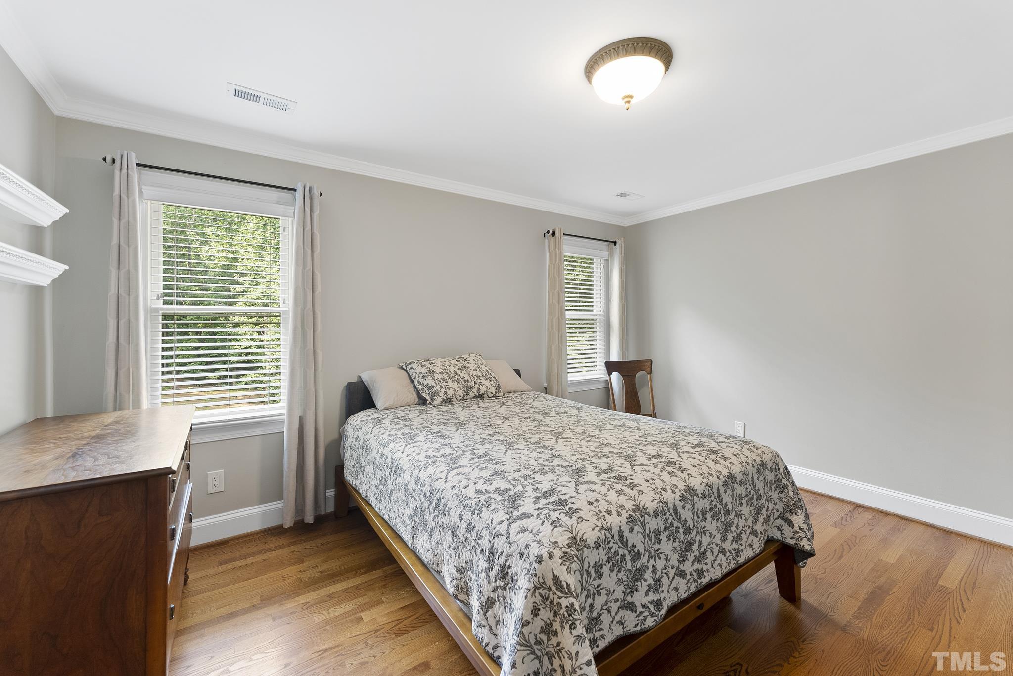 1113 Bentham Drive Raleigh, NC 27614 - Photo 35 of 78 a bedroom with a bed and window with wooden floor