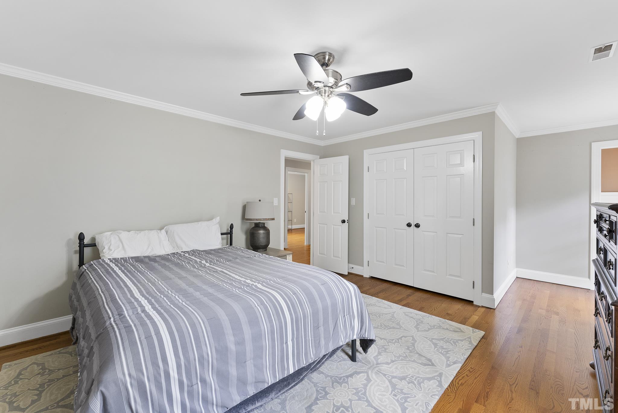 1113 Bentham Drive Raleigh, NC 27614 - Photo 41 of 78 a bedroom with a bed and wooden floor