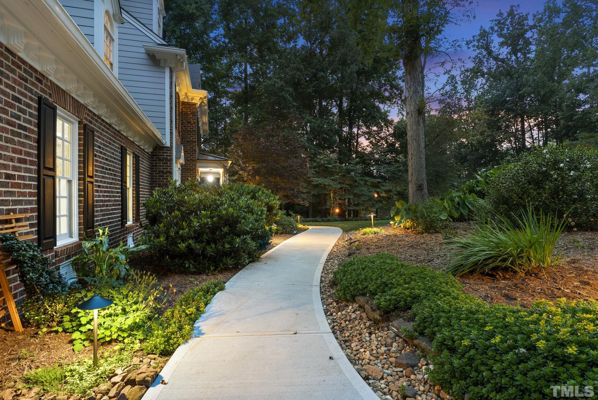 1113 Bentham Drive Raleigh, NC 27614 - Photo 70 of 78 a view of a pathway that has potted plants and large trees