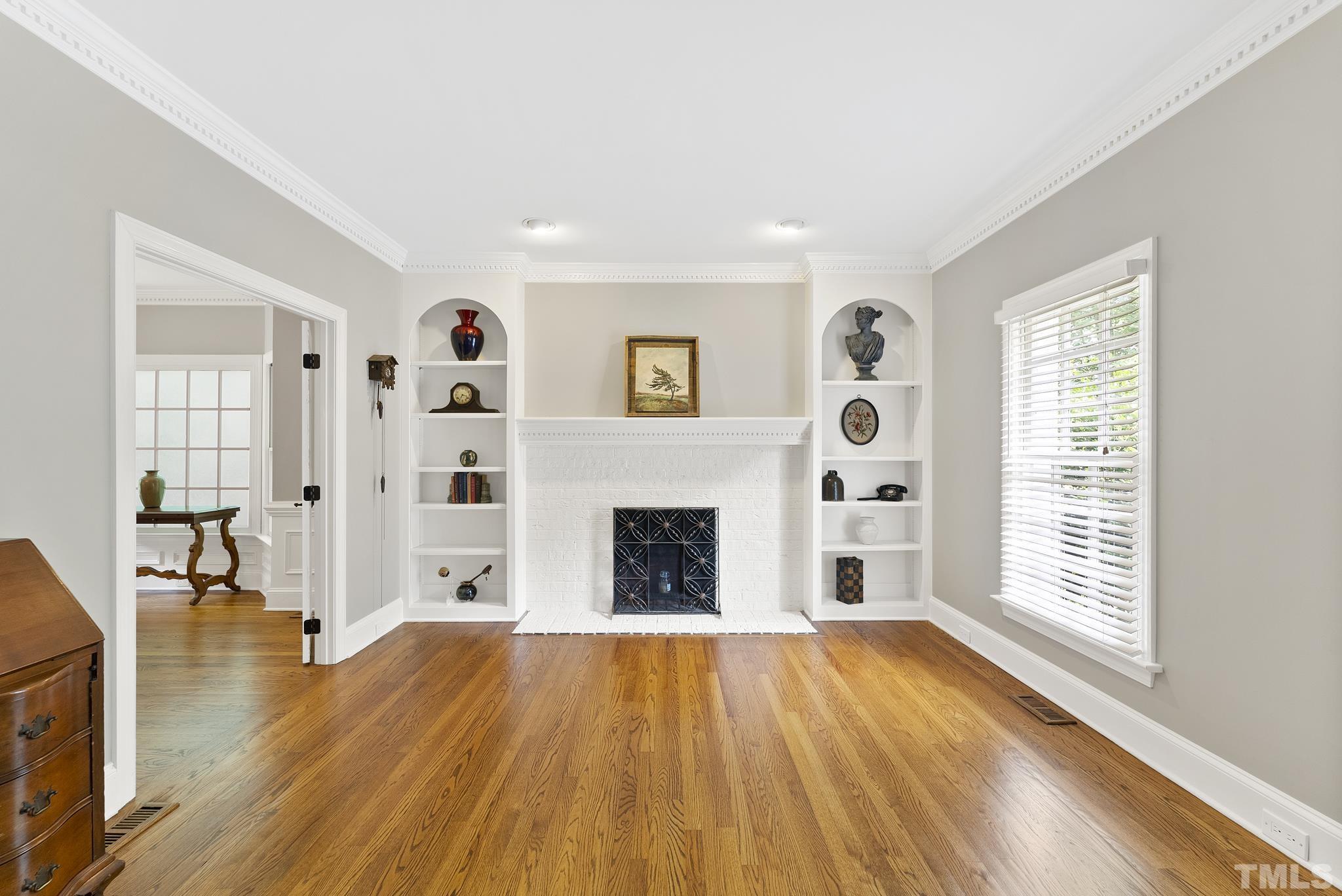 1113 Bentham Drive Raleigh, NC 27614 - Photo 7 of 78 a view of a livingroom with wooden floor and a fireplace