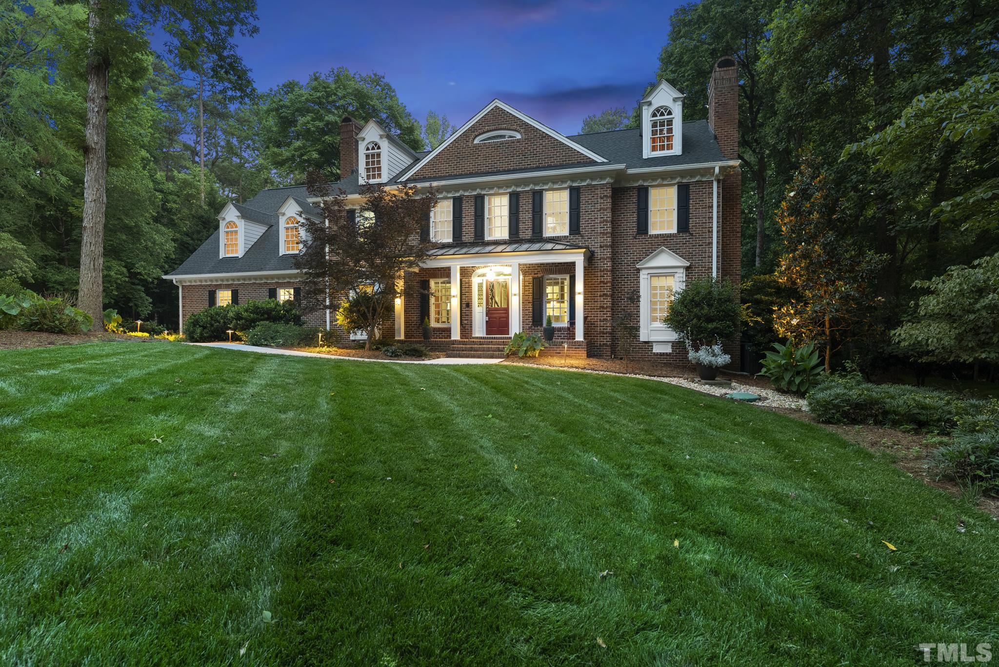 1113 Bentham Drive Raleigh, NC 27614 - Photo 74 of 78 a front view of a house with a yard and potted plants