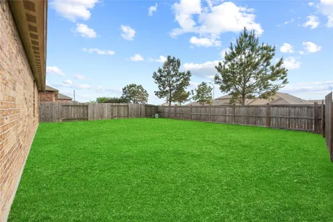 a view of a house with a yard and a garden