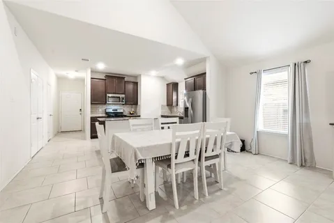 a large open kitchen with a table and chairs