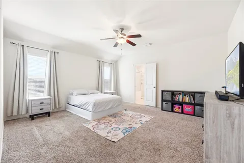 a view of a workspace with furniture and a ceiling fan