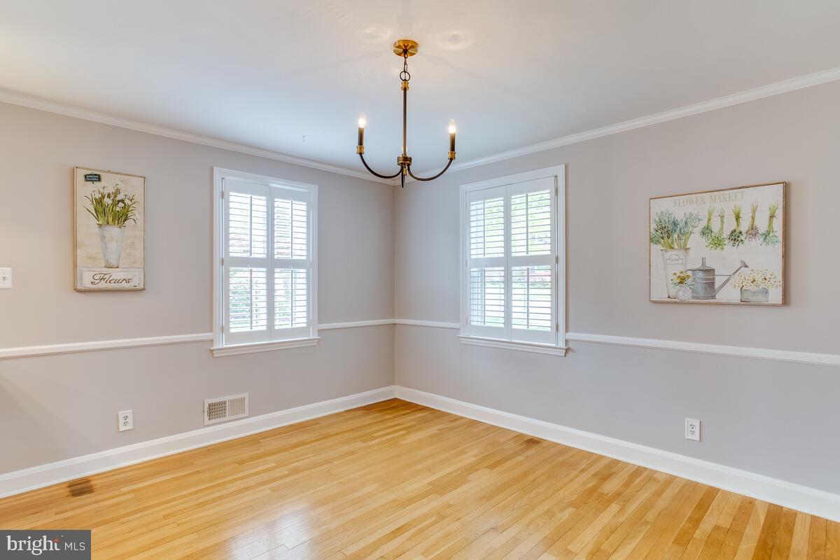 33 Dunmore Road Baltimore, MD 21228 - Photo 14 of 78 a view of an empty room with a window and wooden floor