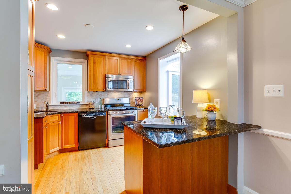 33 Dunmore Road Baltimore, MD 21228 - Photo 18 of 78 a kitchen with granite countertop a sink appliances cabinets and a counter top space