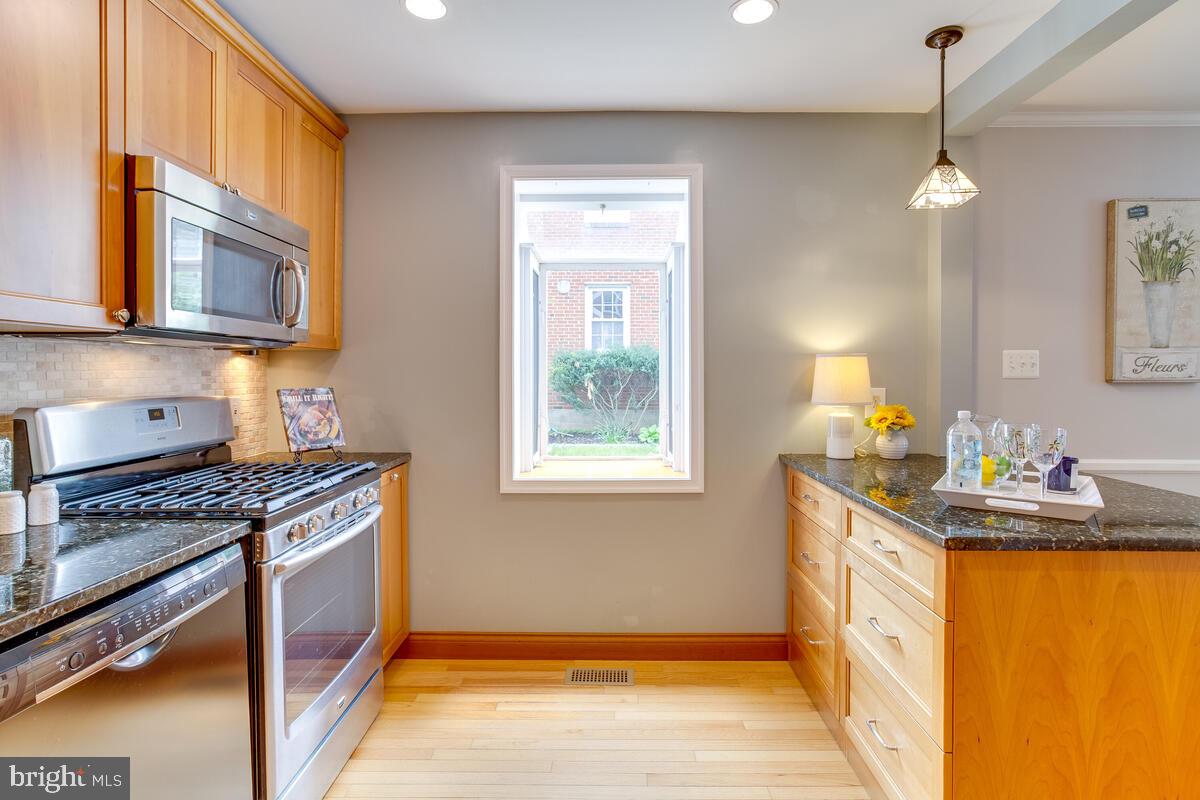 33 Dunmore Road Baltimore, MD 21228 - Photo 20 of 78 a kitchen with stainless steel appliances granite countertop a stove a sink and a microwave
