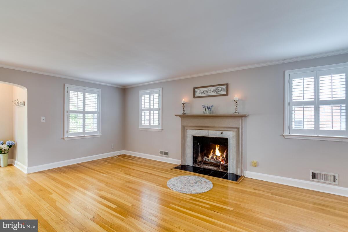 33 Dunmore Road Baltimore, MD 21228 - Photo 9 of 78 a view of an empty room with wooden floor fireplace and a window