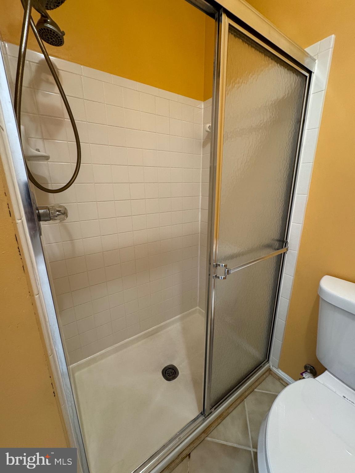 7705 Periwinkle Way, Unit 71 Severn, MD 21144 - Photo 19 of 28 a bathroom with a shower and a toilet