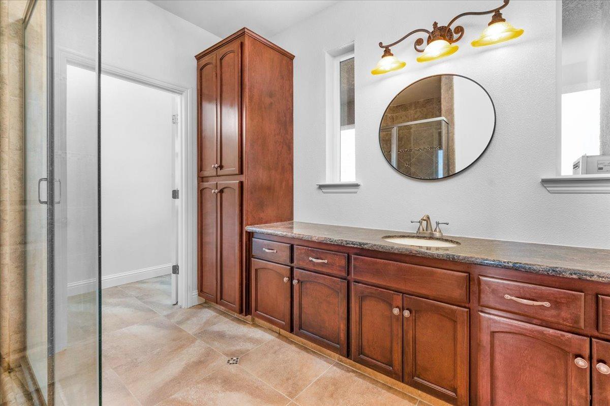 35221 John Albert Drive Madera, CA 93636 - Photo 12 of 22 a bathroom with a sink and a mirror