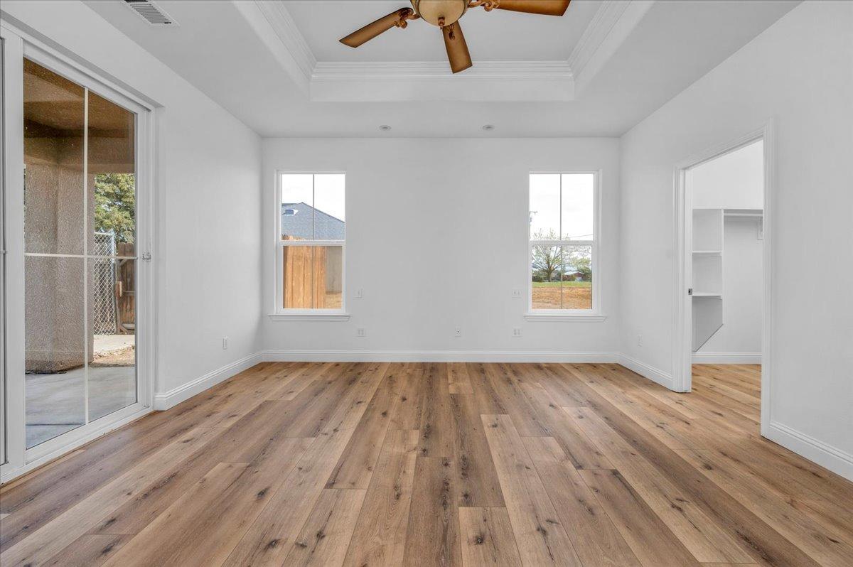 35221 John Albert Drive Madera, CA 93636 - Photo 14 of 22 wooden floor in an empty room with a window
