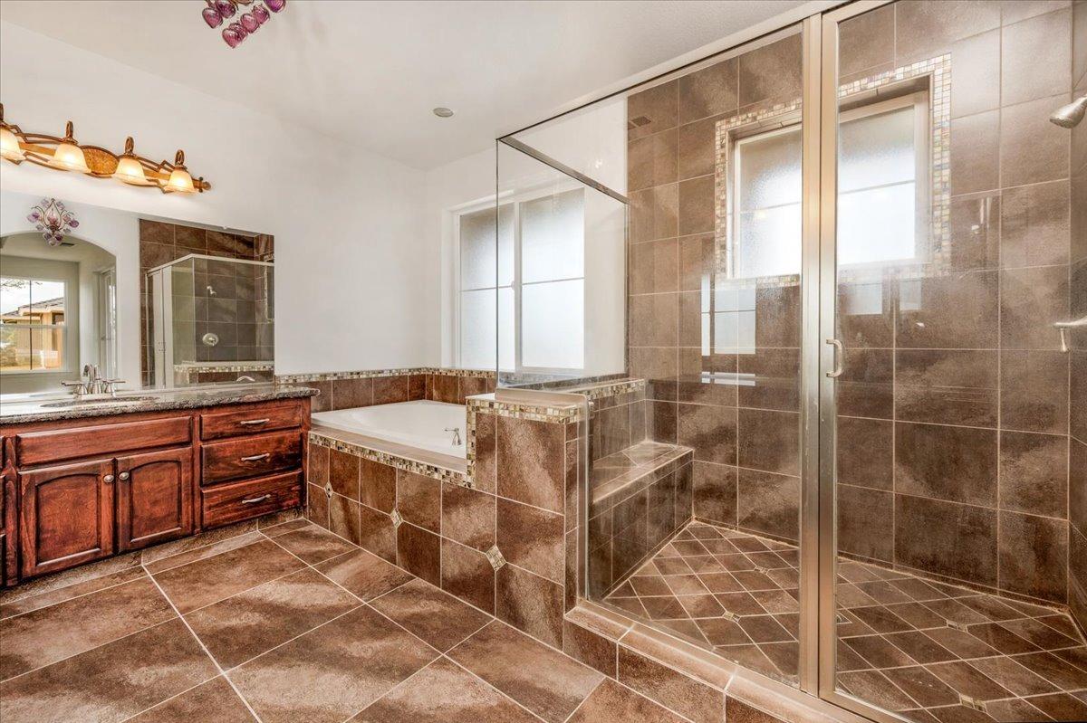 35221 John Albert Drive Madera, CA 93636 - Photo 16 of 22 a spacious bathroom with a tub shower and sink