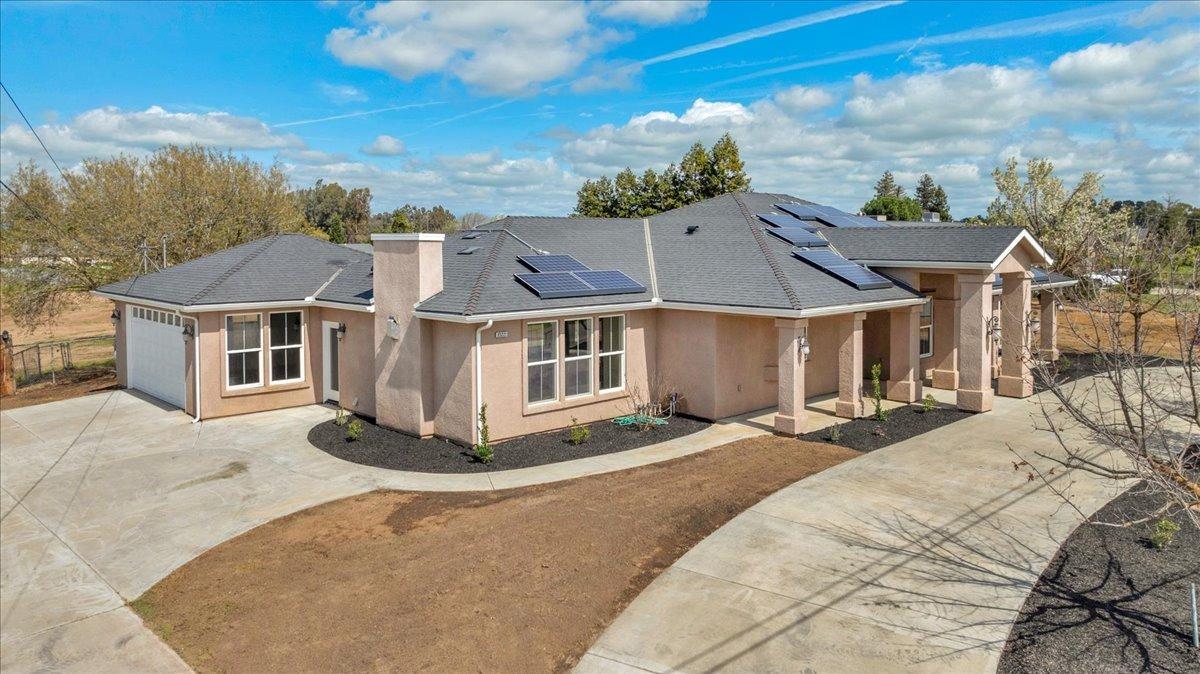 35221 John Albert Drive Madera, CA 93636 - Photo 2 of 22 a view of a white house with a big yard and large trees