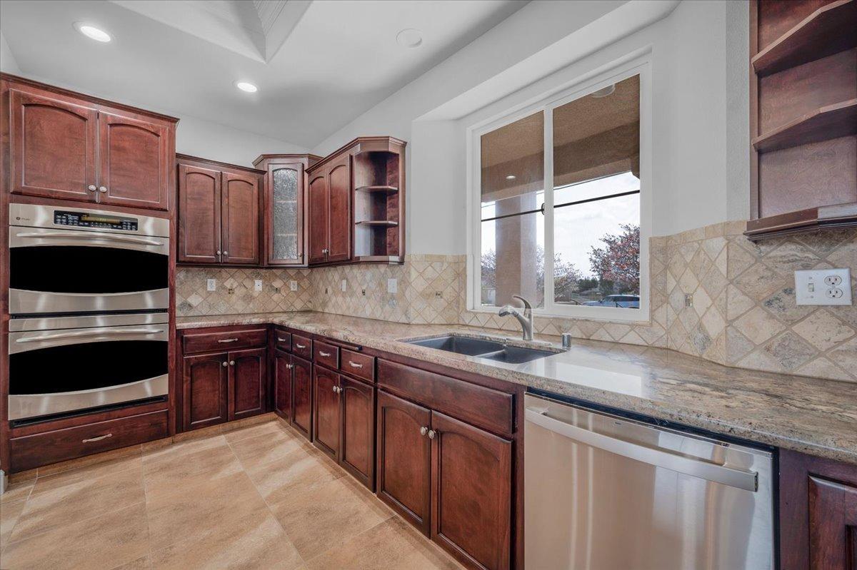 35221 John Albert Drive Madera, CA 93636 - Photo 5 of 22 a kitchen with stainless steel appliances granite countertop wooden cabinets a sink and a oven