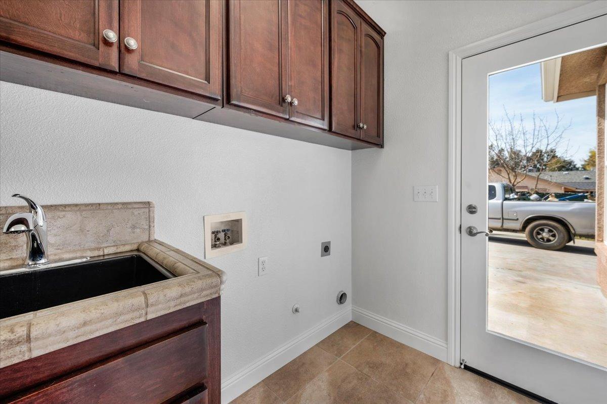 35221 John Albert Drive Madera, CA 93636 - Photo 8 of 22 a kitchen with stainless steel appliances granite countertop a refrigerator and a sink