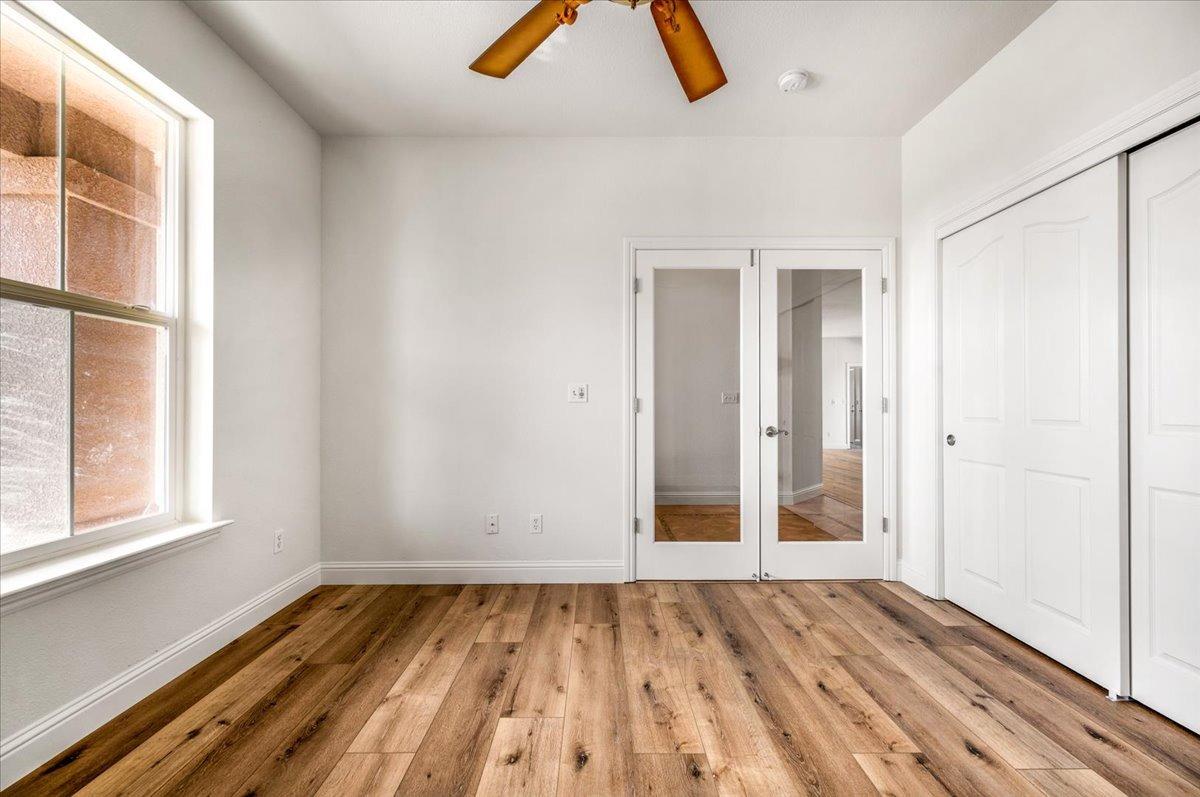 35221 John Albert Drive Madera, CA 93636 - Photo 10 of 22 an empty room with wooden floor and window