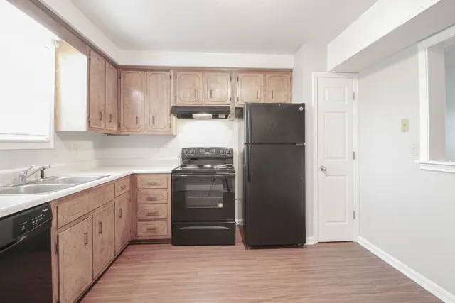 a kitchen with a refrigerator and a sink