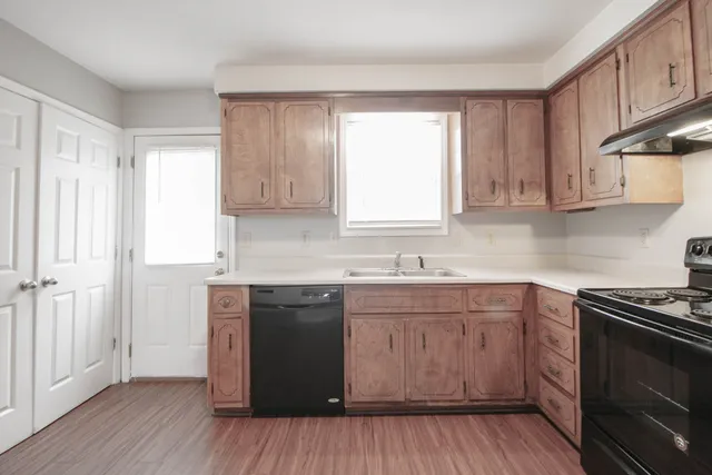 a kitchen with a sink stove and cabinets