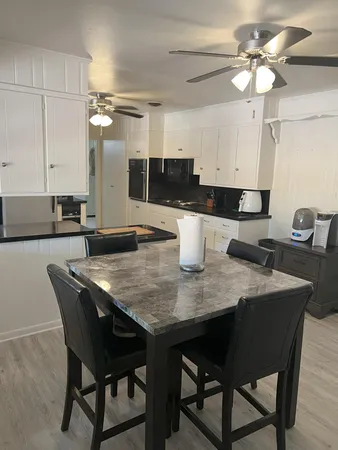 a kitchen with a dining table and chairs