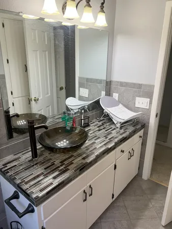 a kitchen with a granite countertop sink stove and cabinets