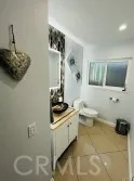 a bathroom with a sink a toilet and mirror