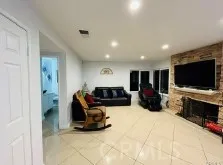 a large room with furniture a flat screen tv and a large window