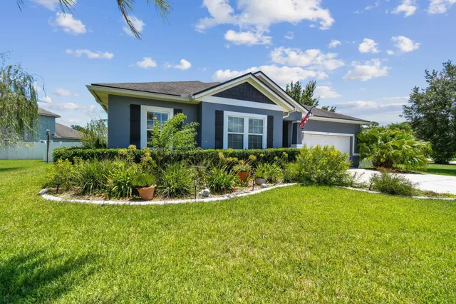 a living room with furniture a flat screen tv and a large window