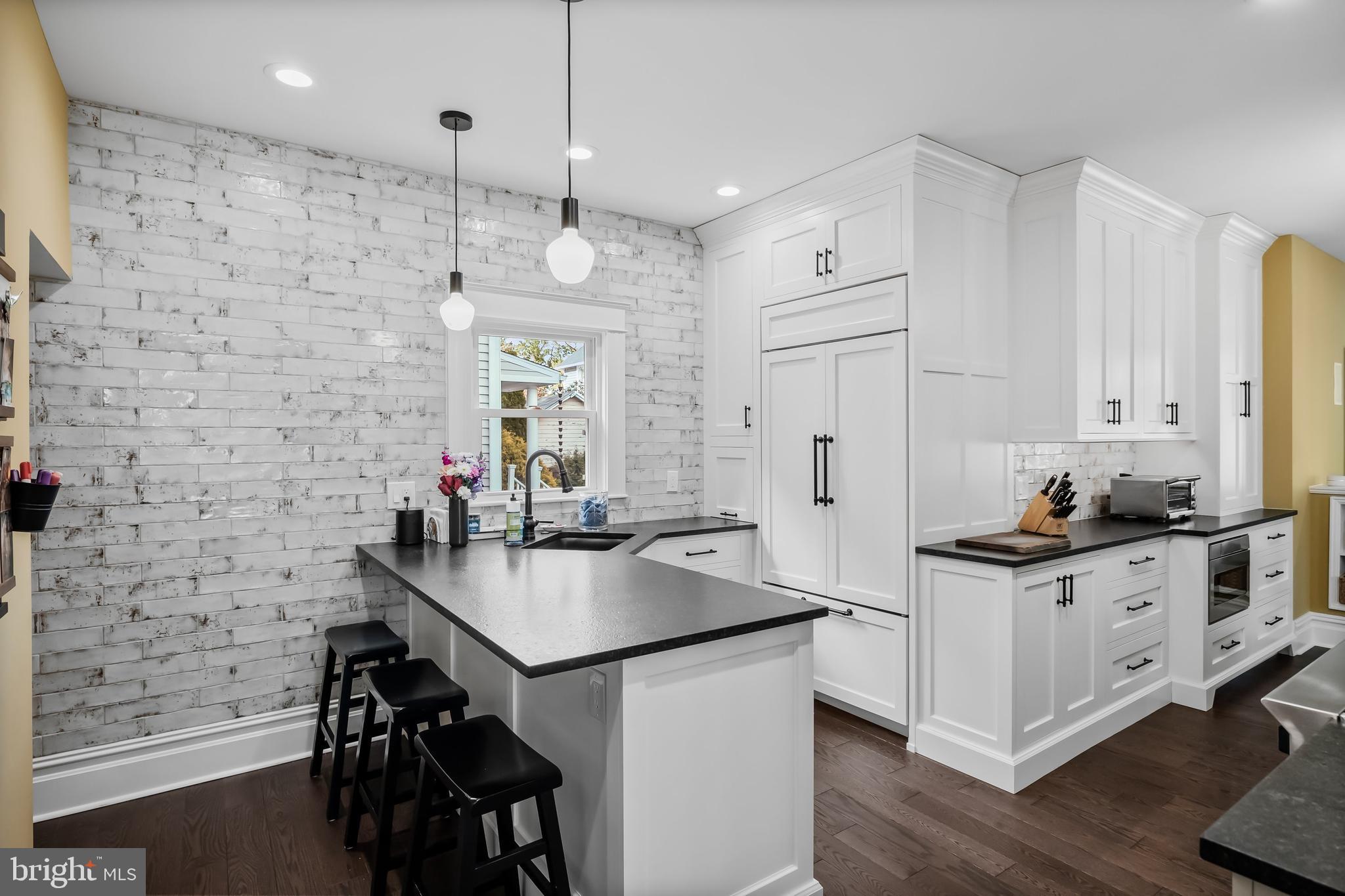 43 Estaugh Avenue Haddonfield, NJ 08033 - Photo 13 of 38 a kitchen with stainless steel appliances a stove a sink a refrigerator and chairs with wooden floor