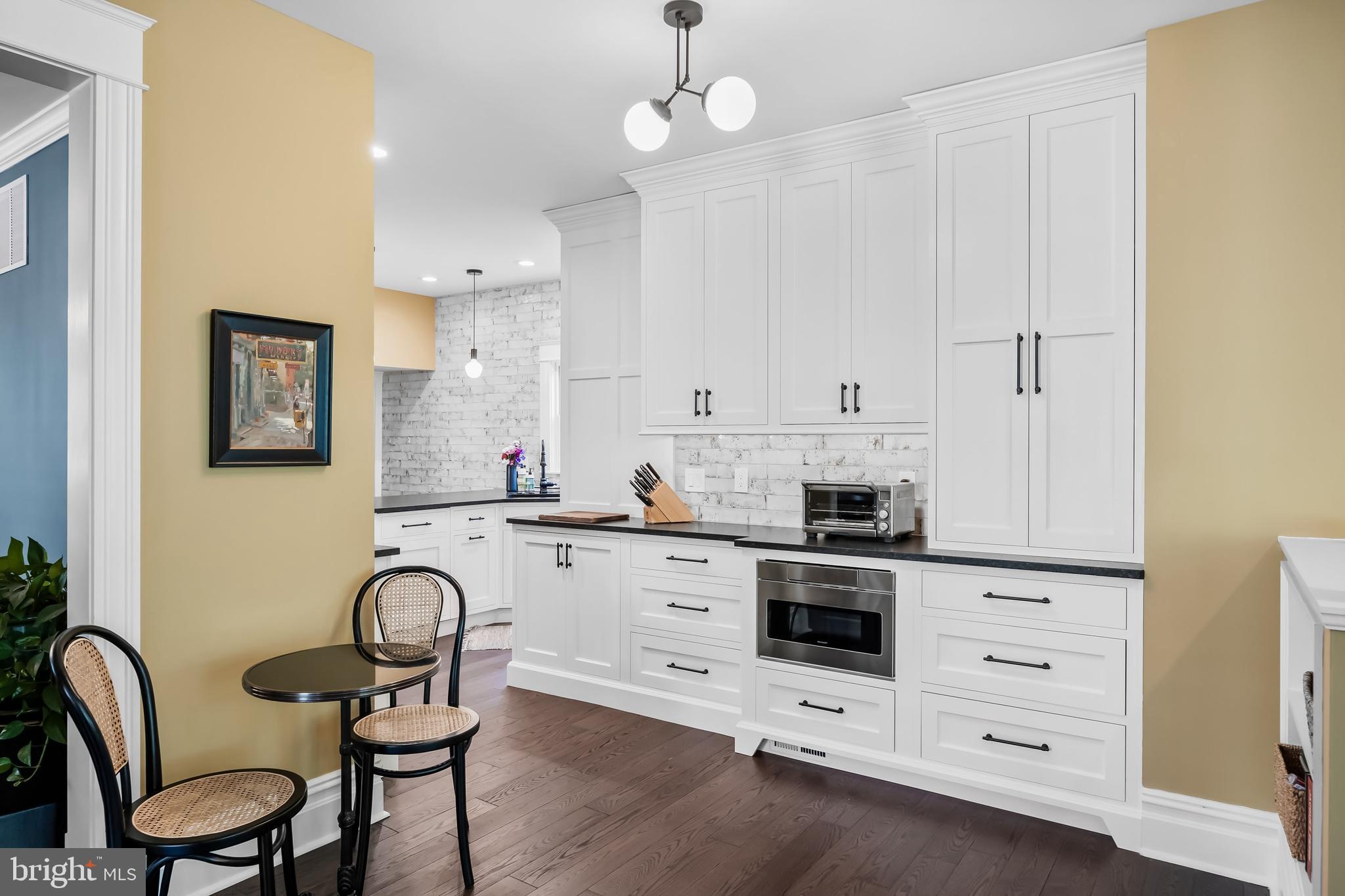 43 Estaugh Avenue Haddonfield, NJ 08033 - Photo 16 of 38 a kitchen with granite countertop white cabinets stainless steel appliances and dining table