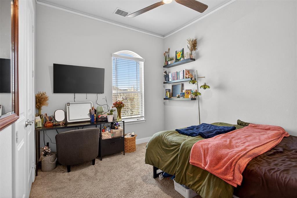 6829 Danridge Road Rowlett, TX 75089 - Photo 14 of 28 a bedroom with a bed and flat screen tv