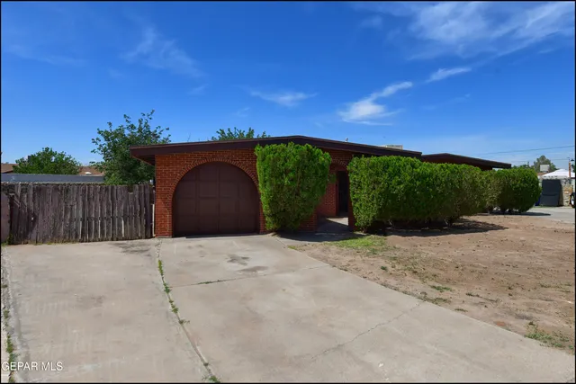 a backyard of a house with a yard and outdoor seating
