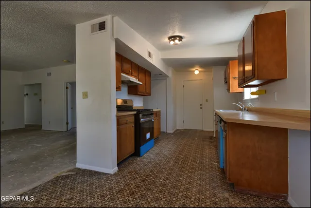 a kitchen with stainless steel appliances granite countertop a stove and a microwave