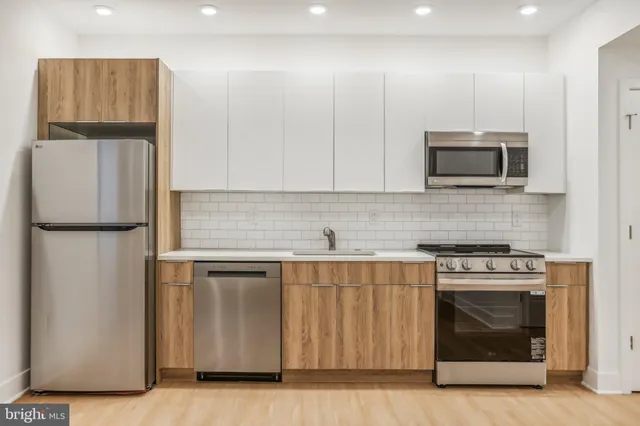 a kitchen with a stove and a microwave