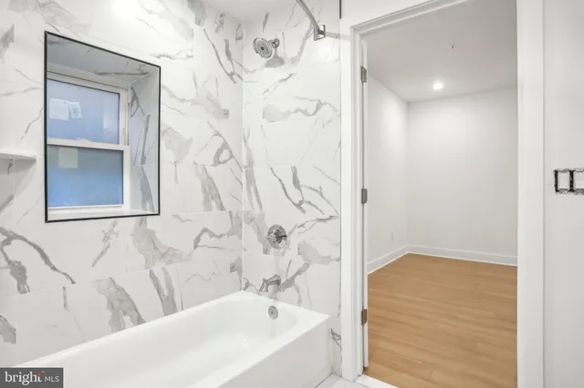 a bathroom with a bathtub and shower