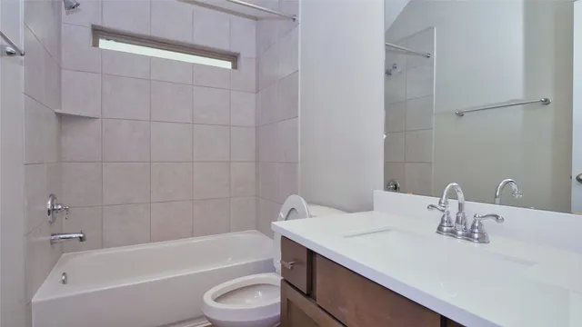 a bathroom with a sink a toilet and bathtub