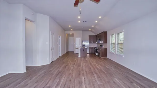 a living room with furniture and kitchen view